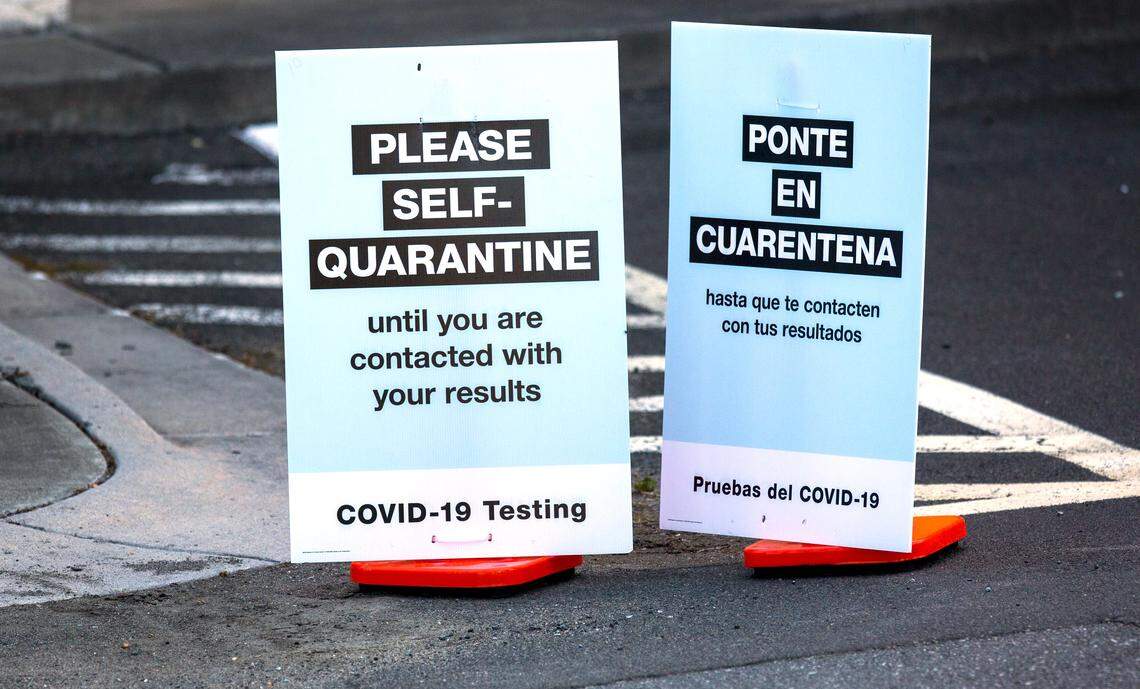 Signs remind customers to self-quarantine after their free drive-through coronavirus testing, administered by Walgreens across the street from their Guess Road location in Durham, N.C., on Friday, May 15, 2020.
