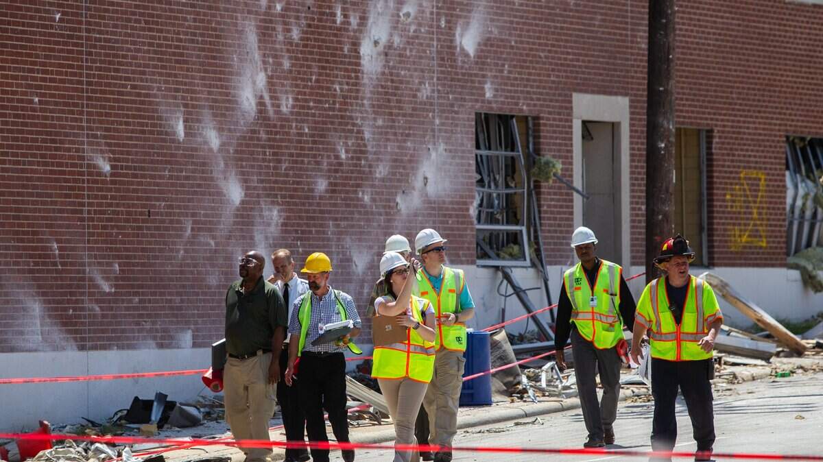 Blast marks scar a brick wall as emergency workers and investigators work the scene Thursday, April 11, 2019, near Brightleaf Square in downtown Durham where a gas explosion killed a man and injured 17 people Wednesday.