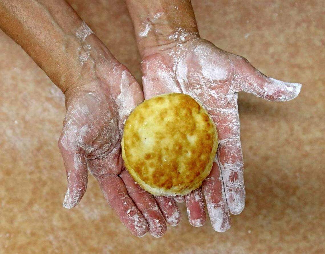 Charlotte-based Bojangles, known for its biscuits, is celebrating National Buttermilk Biscuit Day with celebrity spokesman Dale Earnhardt Jr. Friday, May 13, at the 802 Sears Street, Kannapolis, store.Anita Block holds out a freshly baked biscuit that she made from scratch at Bojangles.