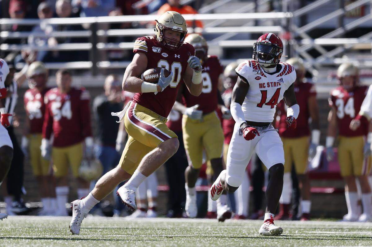 Boston College tight end Hunter Long (80) carries the ball against North Carolina State safety De’Von Graves (14) during the first half of an NCAA college football game in Boston, Saturday, Oct. 19, 2019. (AP Photo/Michael Dwyer)