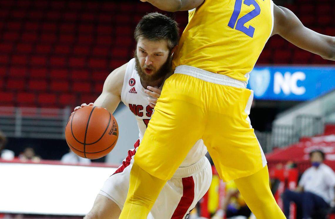 N.C. State’s Braxton Beverly (10) drives around Pittsburgh’s Abdoul Karim Coulibaly (12) during the second half of N.C. State’s 65-62 victory over Pittsburgh at PNC Arena in Raleigh, N.C., Sunday, February 28, 2021.