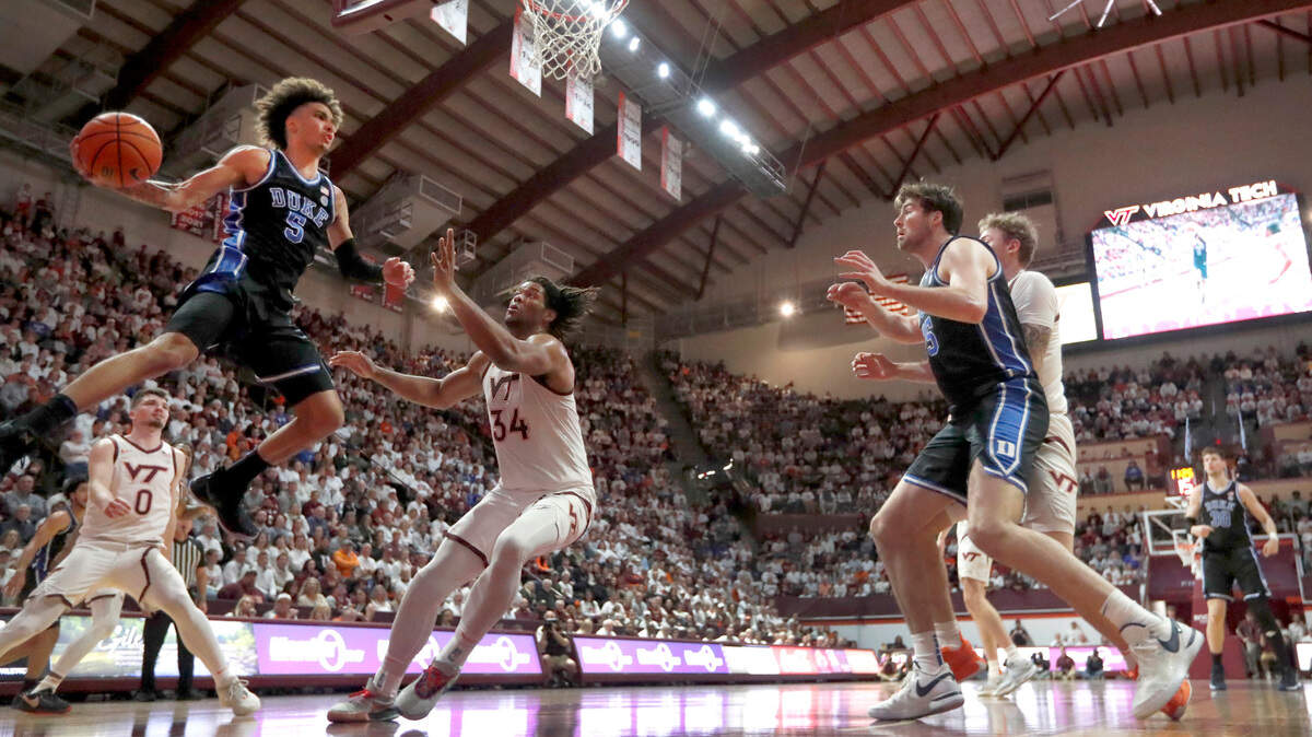 Duke’s Tyrese Proctor (5) passes to an open Jeremy Roach, who drills a three-pointer during the second half of Duke’s 77-67 victory over Virginia Tech at Cassell Coliseum in Blacksburg, Va., Monday, Jan. 29, 2024.
