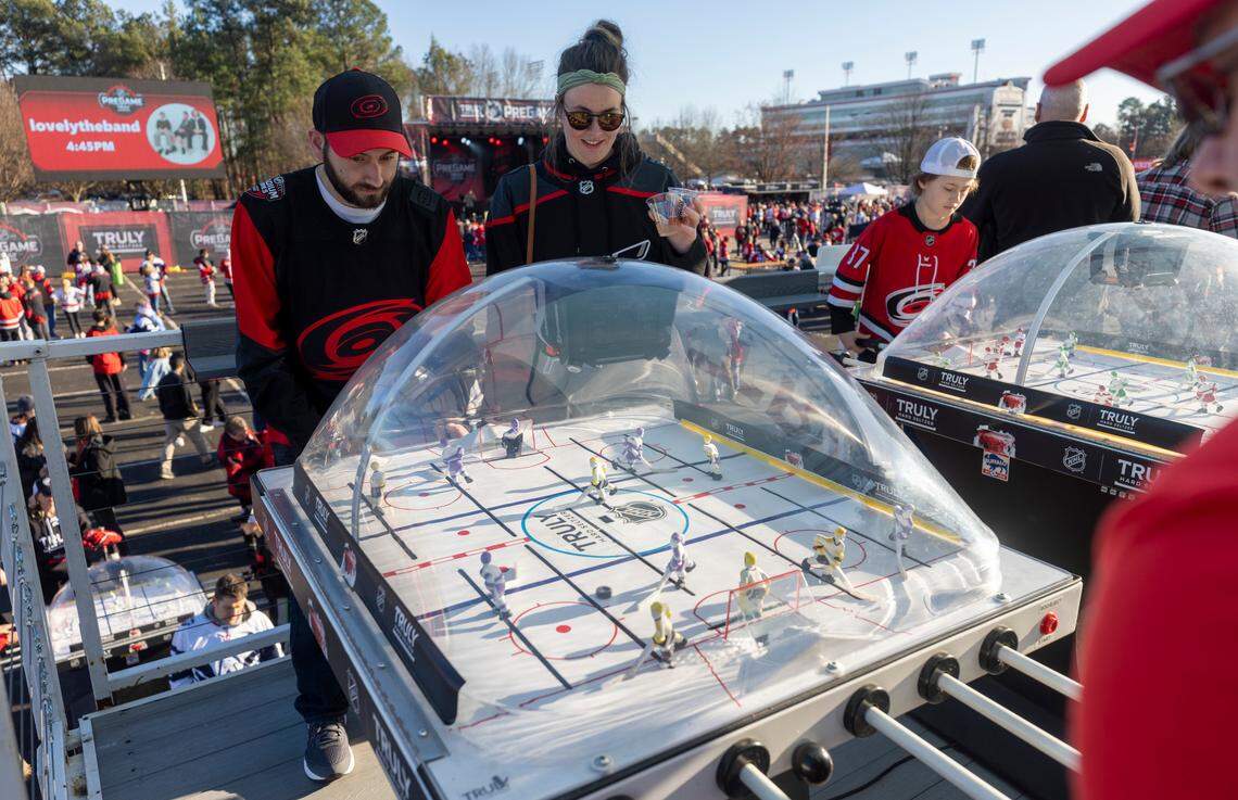 Visitors to Fan Fest play table top hockey prior to the Stadium Series game between the Washington Capitals and the Carolina Hurricanes on Saturday, February 18, 2022 at Carter-Finley Stadium in Raleigh, N.C.