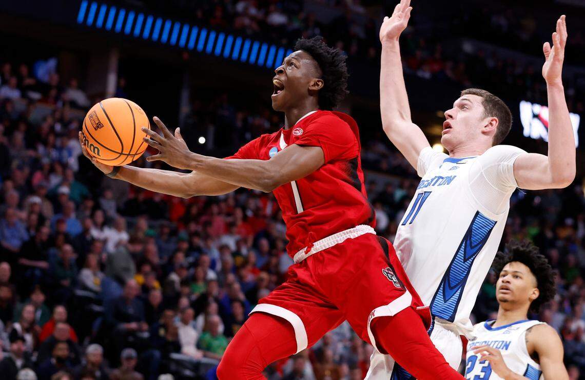 N.C. State’s Terquavion Smith (0) heads to the basket past Creighton’s Ryan Kalkbrenner (11) during the first half of N.C. State’s game against Creighton in the first round of the NCAA Tournament at Ball Arena in Denver, Colo., Friday, March 17, 2023.