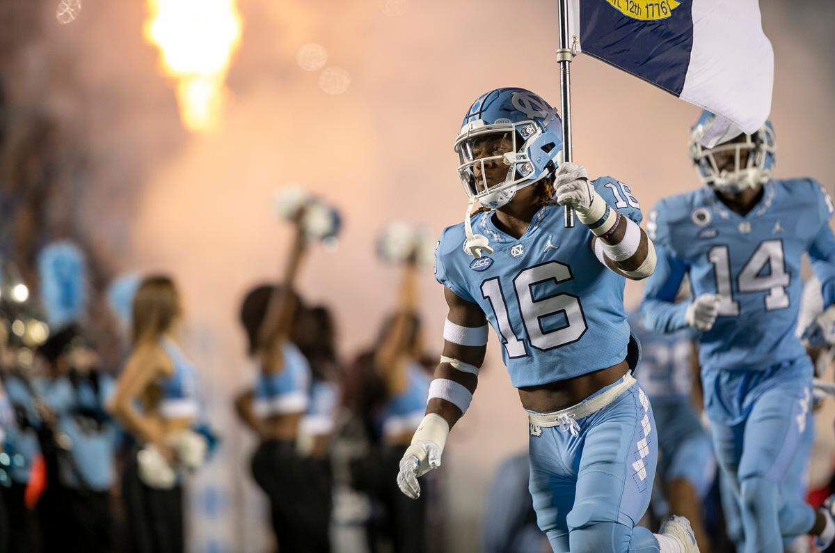 North Carolina’s DeAndre Boykins (16) leads the Tar Heels into Kenan Stadium for their game against Pitt on Saturday, October 29, 2022 in Chapel Hill, N.C.