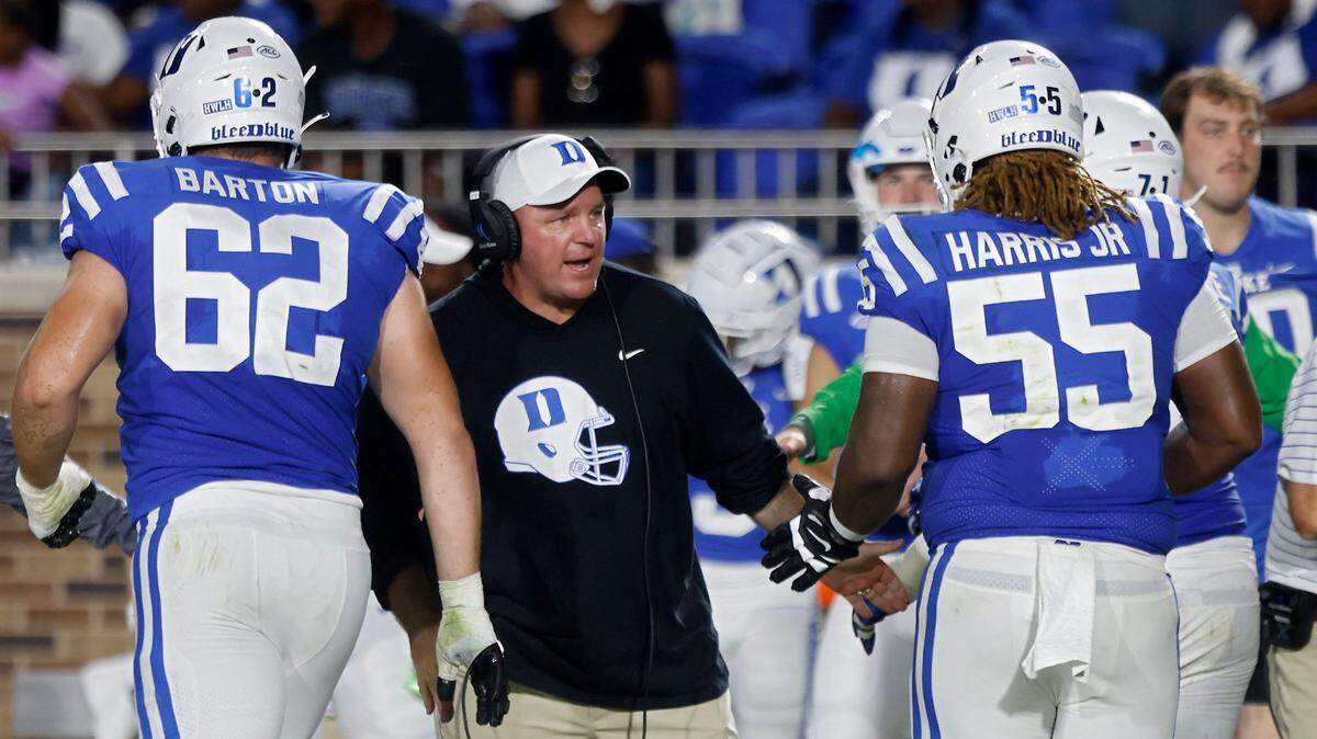 Duke head coach Mike Elko high fives players following a a touchdown during the first half of the Blue Devils season opener against Temple at Wallace Wade Stadium on Friday, Sept. 2, 2022, in Durham, N.C.
