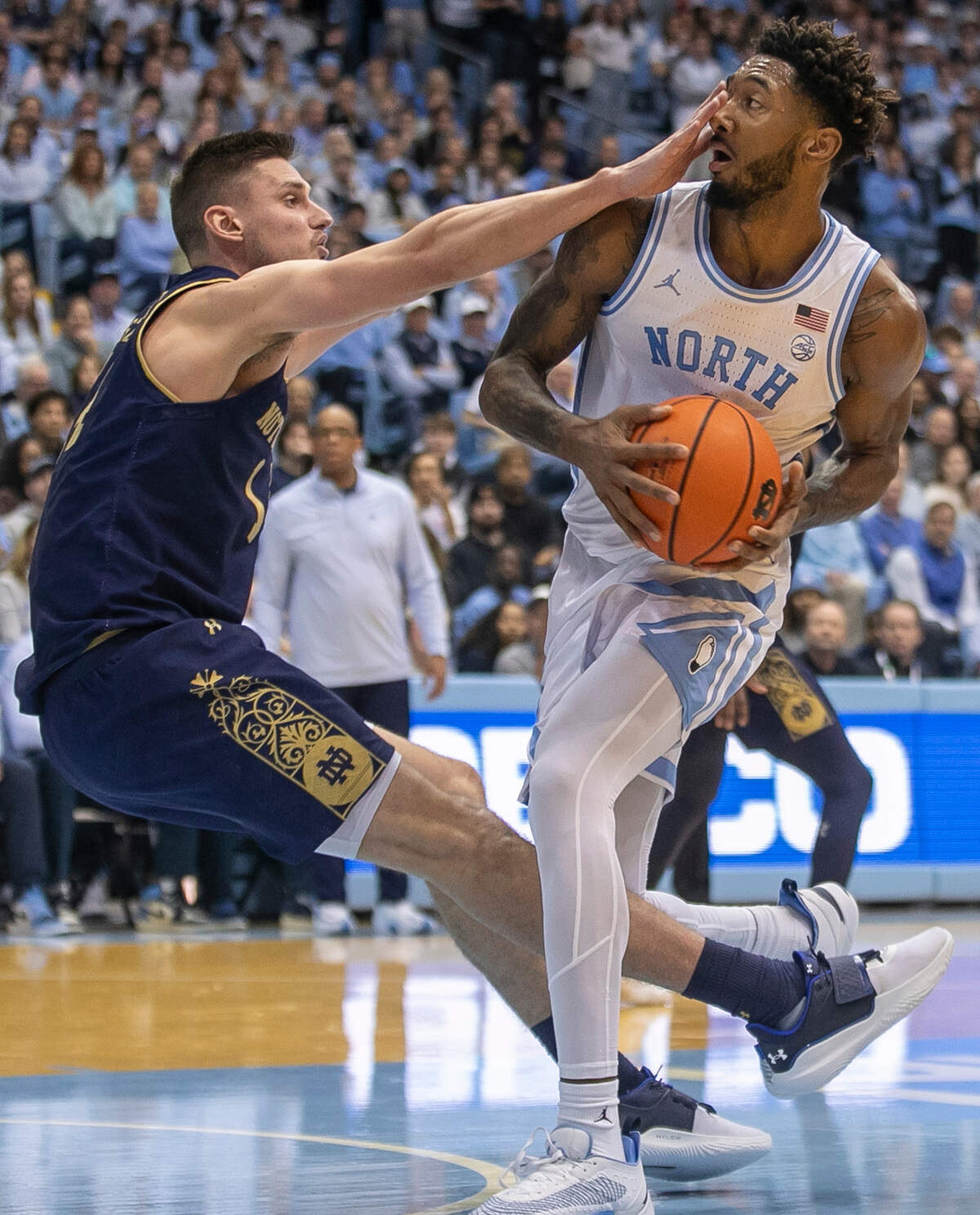 Notre Dame’s Nate Laszewski (14) works to stop North Carolina’s Leaky Black (1) as he drives to the basket in the second half on Saturday, January 7, 2023 at the Smith Center in Chapel Hill, N.C.