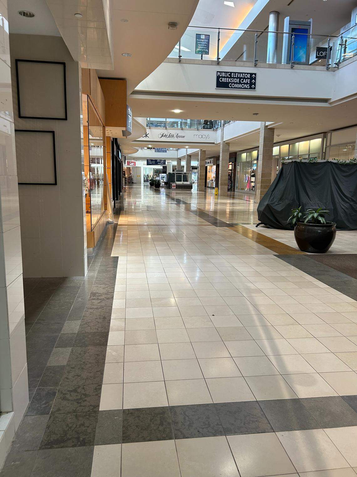 An empty corridor inside Triangle Town Center Monday, three days after a shooting that injured three people.