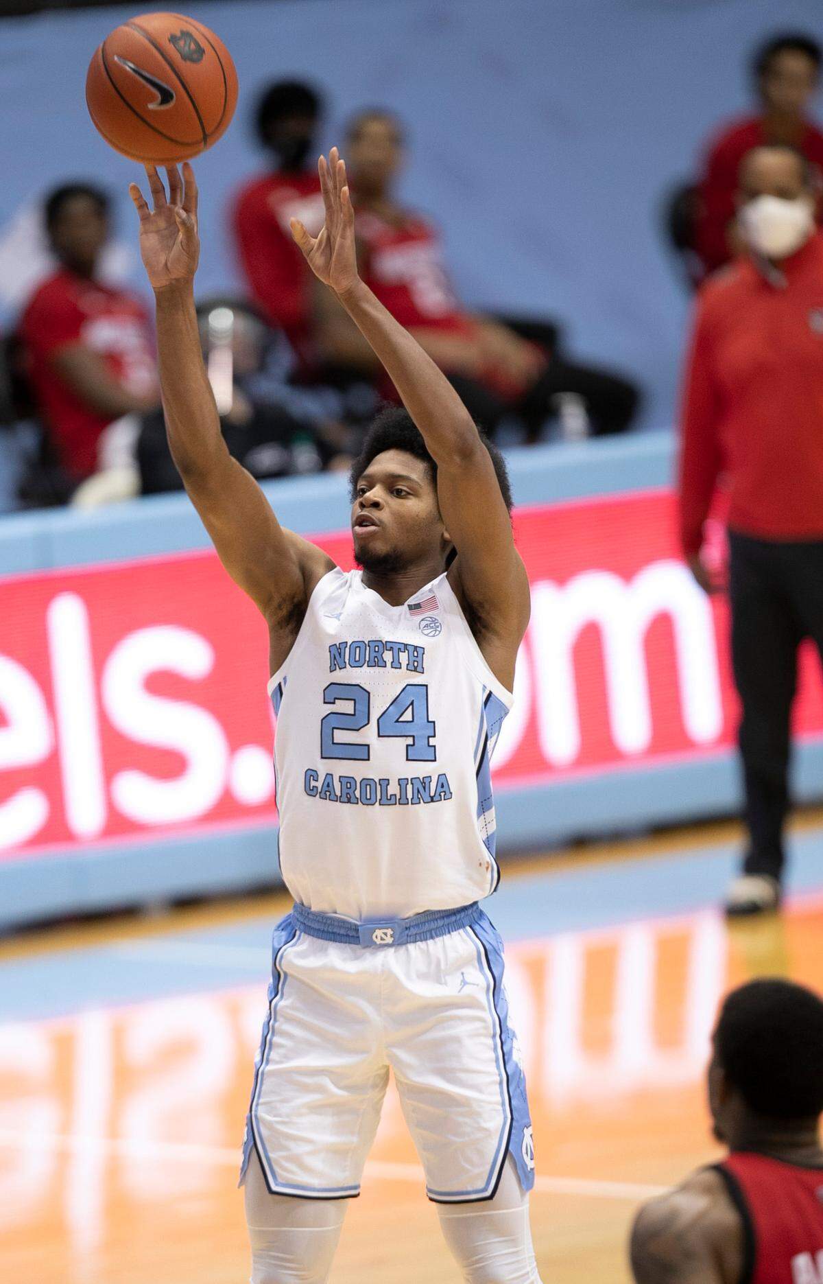North Carolina’s Kerwin Walton (24) lunches a three-point shot in the second half against N.C. State on Saturday, January 23, 2021 at the Smith Center in Chapel Hill, NC.