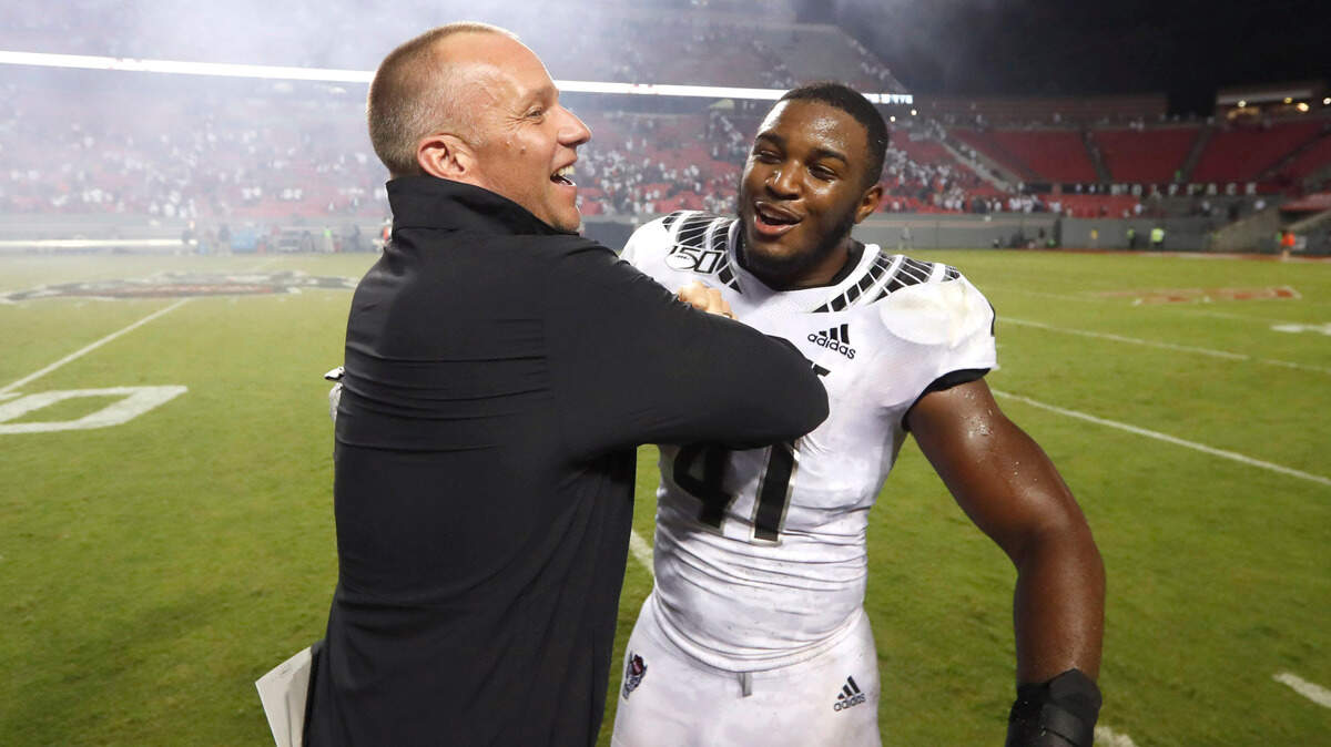 N.C. State head coach Dave Doeren celebrates with Isaiah Moore (41) after the Wolfpack’s victory over Syracuse in 2019. Moore was a redshirt sophomore in 2019 when NC State went 4-8.