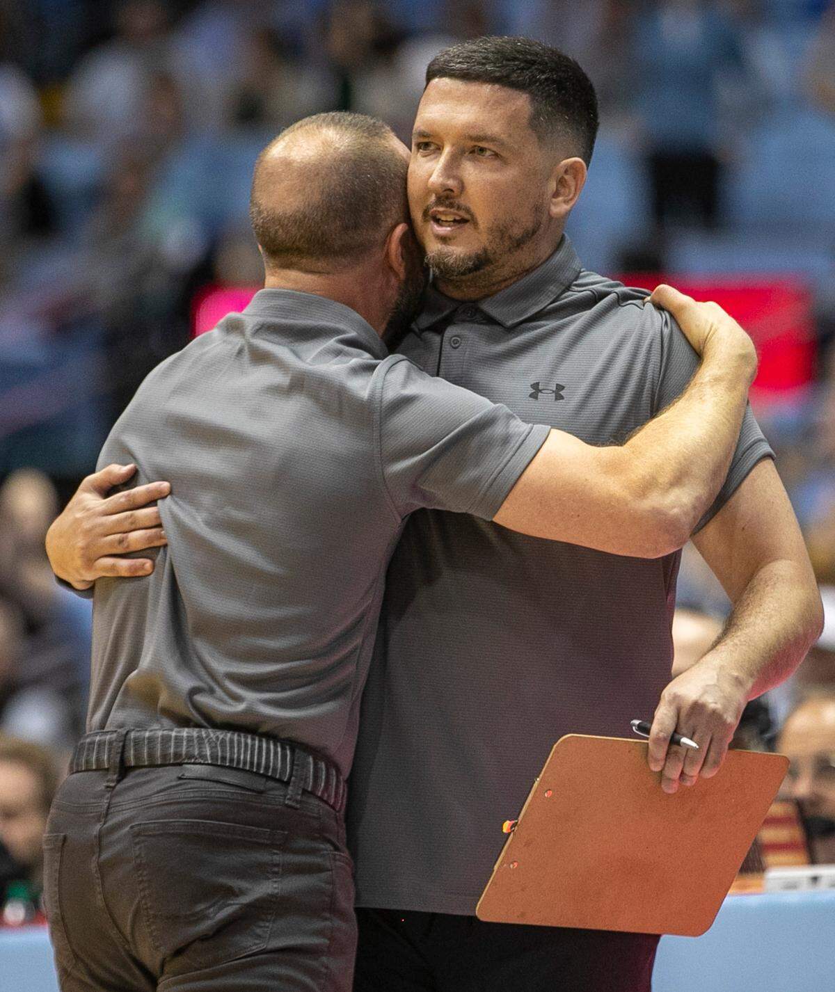 College of Charleston coach Pat Kelsey embraces assistant coach Thomas Carr, as he reacts to a foul against his team, in the first half against North Carolina on Friday, November 11, 2022 at the Smith Center in Chapel Hill, N.C.