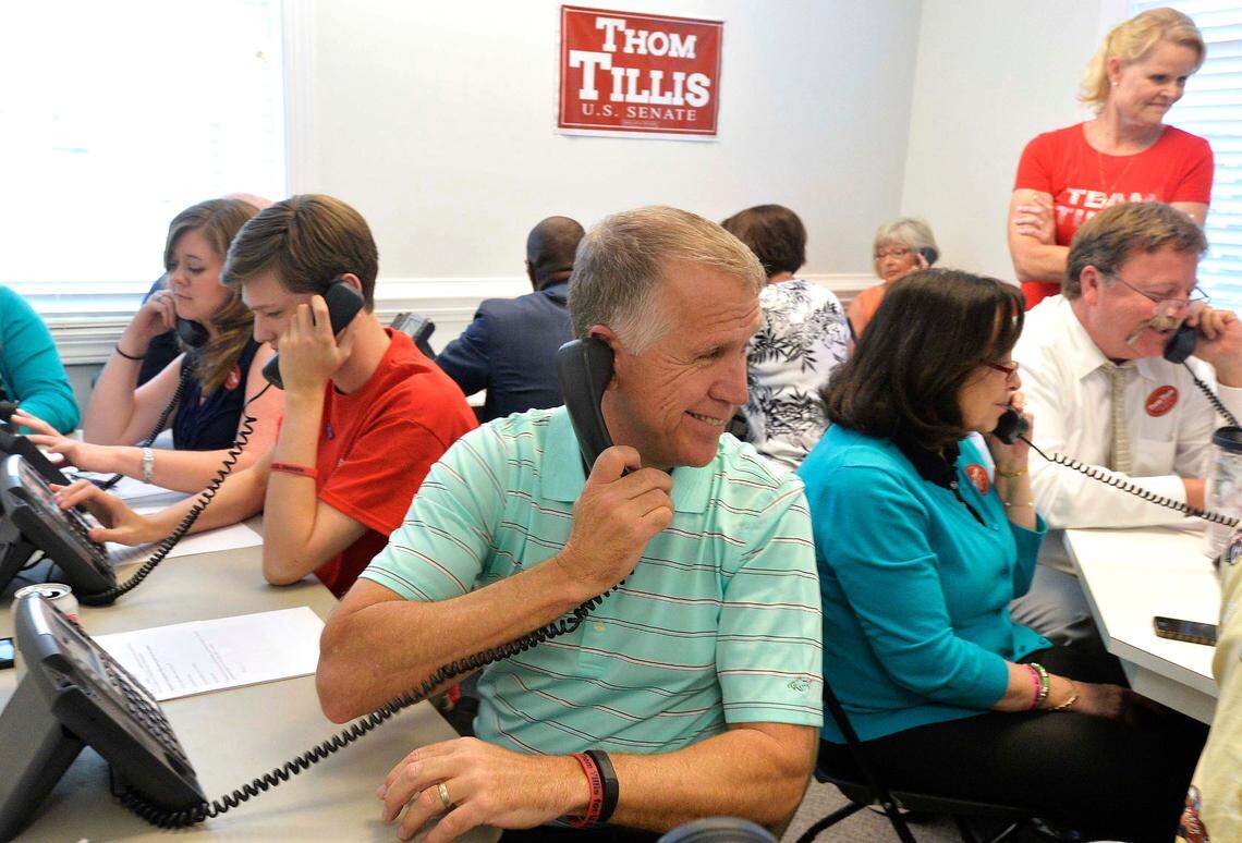 US Senate candidate Thom Tillis participates in a phone bank calling voters during a drop-in visit at Tillis for US Senate Campaign Headquarters in May 2014 in Cornelius.