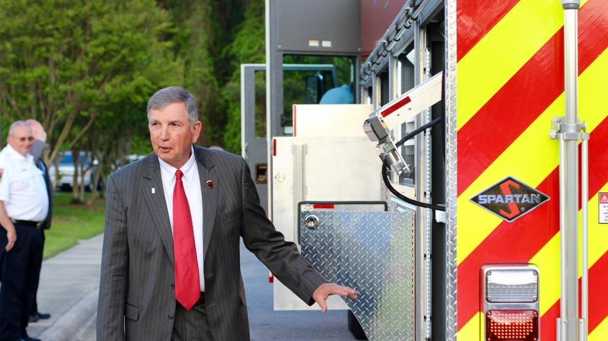 Fuquay-Varina Mayor John Byrne inspects one of the town’s firetrucks in this file photo.