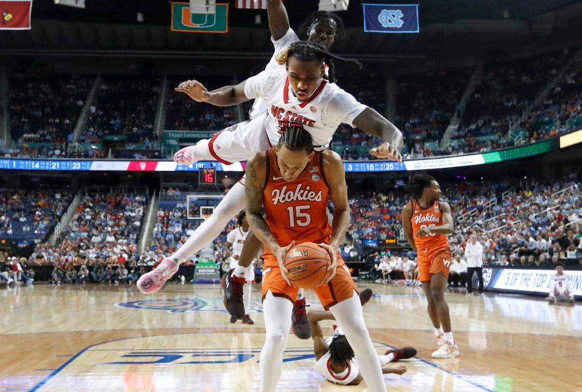 N.C. State’s Greg Gantt (23) goes over Virginia Tech’s Lynn Kidd (15) as he goes for the ball during N.C. State’s 97-77 victory over Virginia Tech in the second round of the ACC Men’s Basketball Tournament in Greensboro, N.C., Wednesday, March 8, 2023.