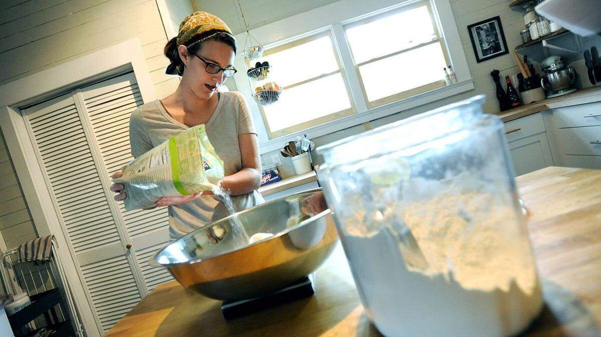 East Durham Bake Shop owner Ali Rudel measures out flour when her bakery was her kitchen. Her shop opens Wednesday on Driver Street in Durham.