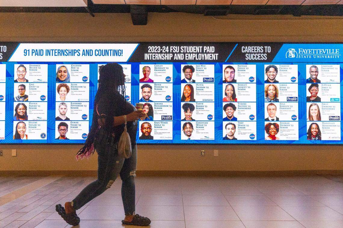 A Fayetteville State University student walks past a display featuring paid internship recipients on Fayetteville State’s campus Friday, Oct. 20, 2023. Fayetteville State began offering heavily discounted tuition through the NC Promise Tuition Program in fall 2022.