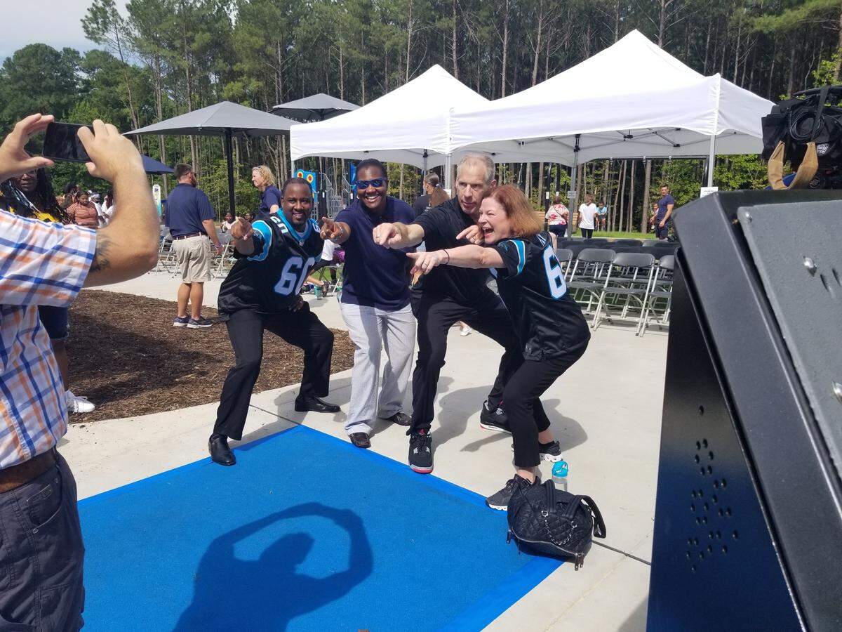 Raleigh City Council members post with former Carolina Panthers player Kevin Donnalley at the Barwell Road Park playground ribbon cutting. From left to right: Stormie Forte, Corey Branch, Donnalley and Mary-Ann Baldwin.