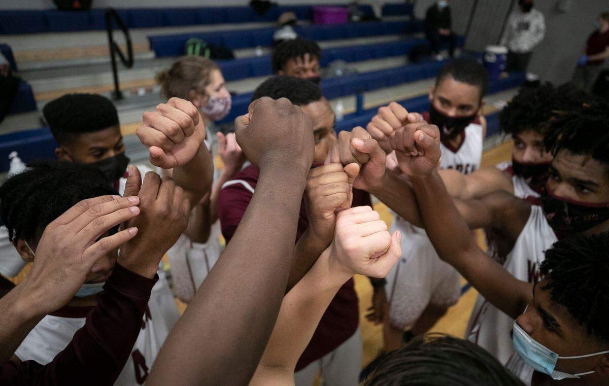 Warren County High School coach Toriano McRae Jr. huddles with his players during the closing minute of play against Bunn High School on Tuesday, February 2, 2021 in Warrenton, N.C.