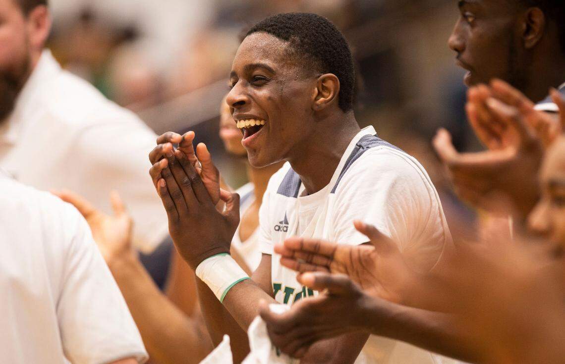 Kinston High School senior Jyrah Canady (5) cheers for his teammates during their second round playoff game against Washington High School at their home gym in Kinston, N.C. on Feb. 24, 2022.