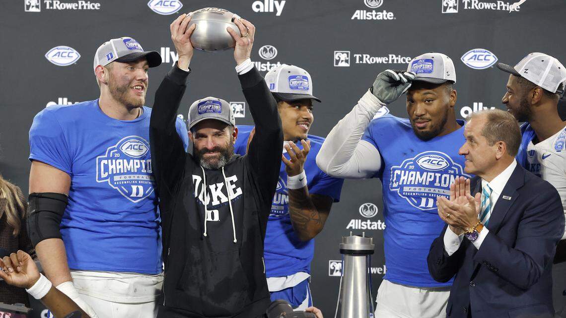 Duke head coach Manny Diaz celebrates with his team after being presented the ACC Football Championship trophy following the Blue Devils’ 27-20 overtime win over Virginia on Saturday, Dec. 6, 2025, at Bank of America Stadium in Charlotte, N.C.