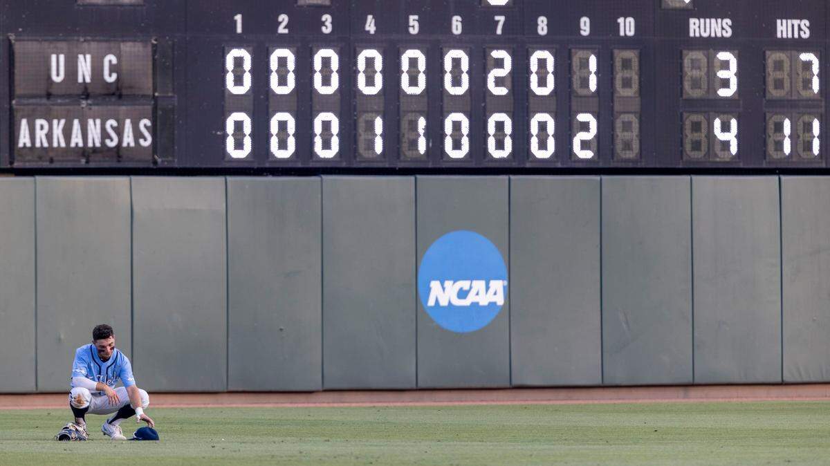 North Carolina left fielder Mikey Madej (2) gathers his thoughts alone in left field following the Tar Heels 4-3 loss to Arkansas in the NCAA Super Regional series on Sunday, June 12, 2022 at Boshamer Stadium in Chapel Hill, N.C.