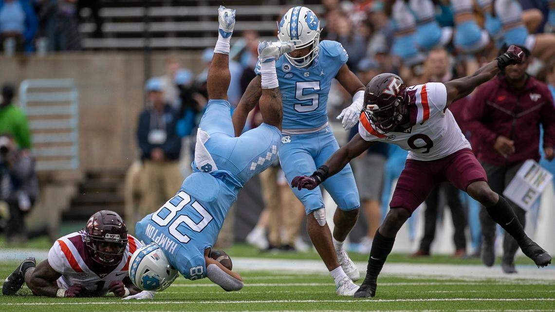 North Carolina’s Omarion Hampton (28) hurdles over Virginia Tech’s Chamarri Conner (1) for a nine yard gain in the first quarter on Saturday, October 1, 2022 at Kenan Stadium in Chapel Hill, N.C.