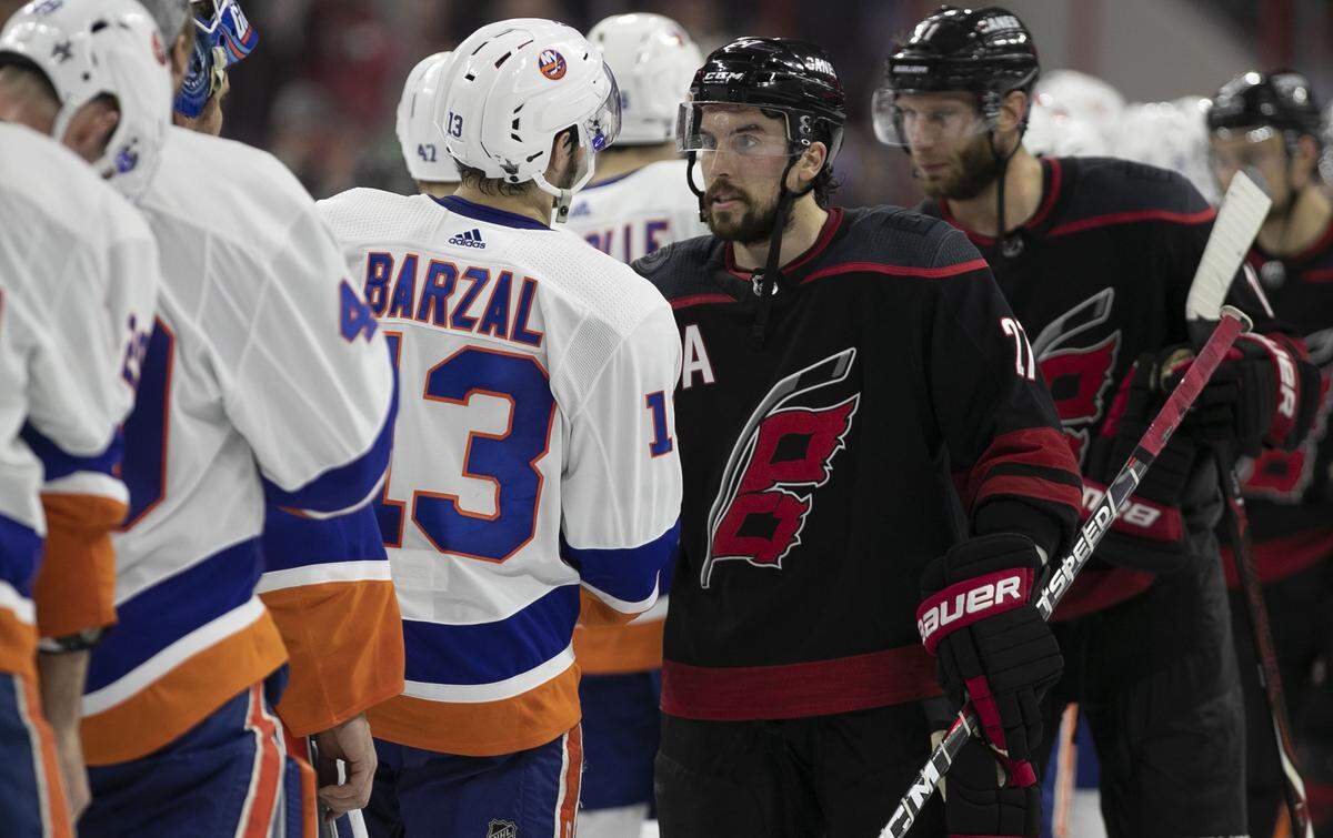 Carolina Hurricanes’ Justin Faulk (27) shakes hands with New York Islanders’ Matthew Barzal (13) following the Hurricanes’ 5-2 victory in Game 4 of their Stanley Cup series on Friday, May 3, 2019 at PNC Arena in Raleigh, N.C.