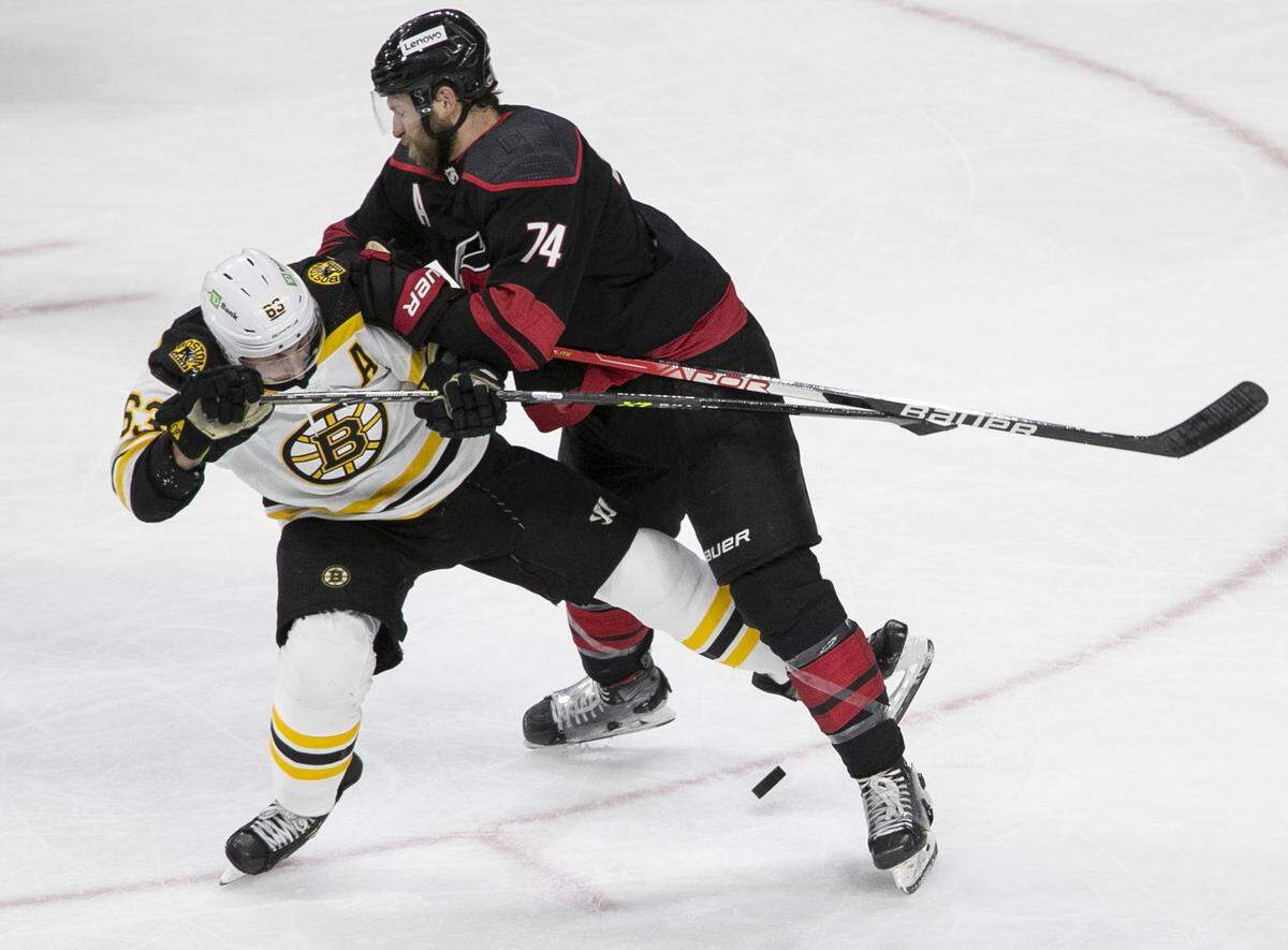 Carolina Hurricanes Jaccob Slavin (74) checks Bostons Brad Marchand (63) in the second period on Tuesday, May 10, 2022 during game five of their of their Stanley Cup first round series at PNC Arena in Raleigh, N.C.