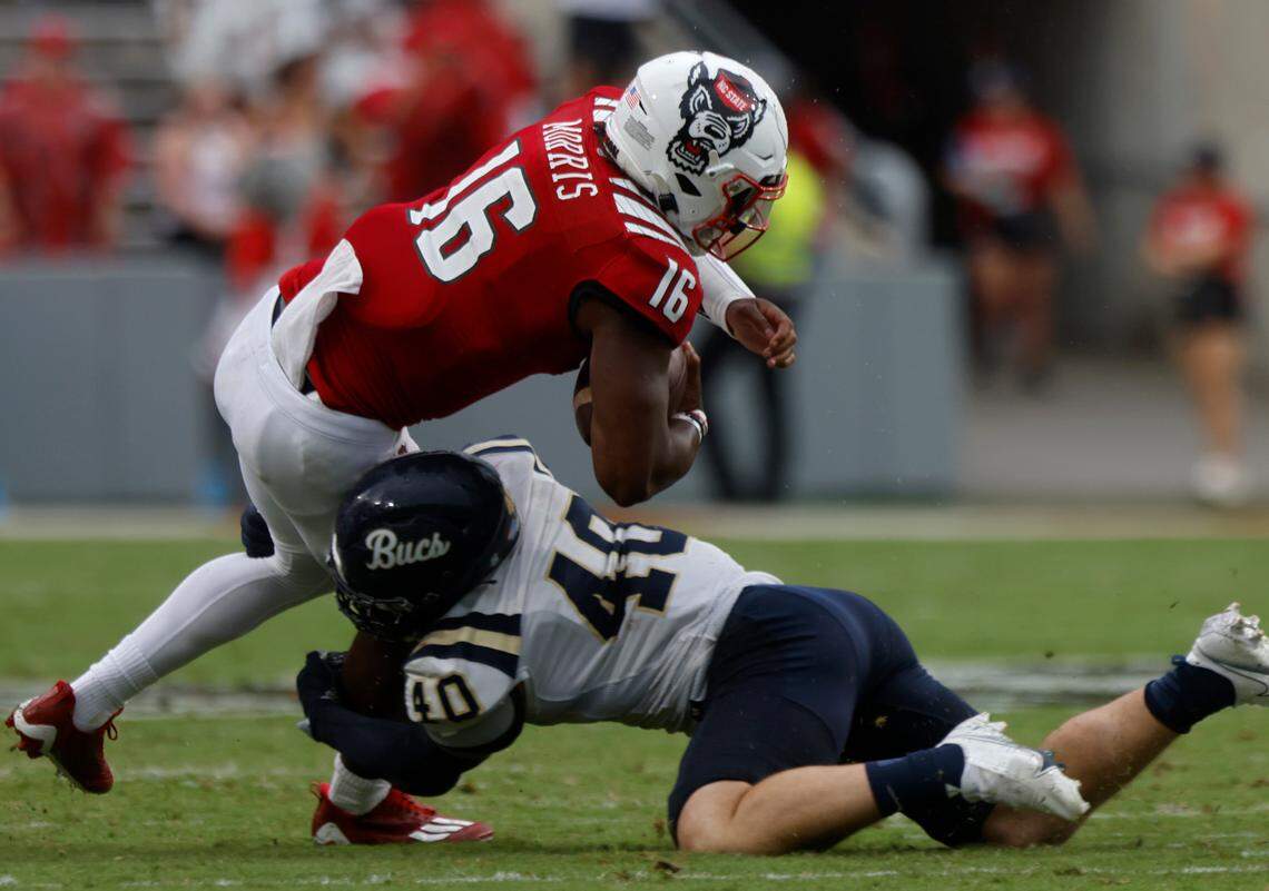N.C. State quarterback MJ Morris is brought down by Charleston Southern linebacker Garrett Sayegh during the second half of the Wolfpack’s game against Charleston Southern on Saturday, Sept. 10, 2022, at Carter-Finley Stadium in Raleigh, N.C.