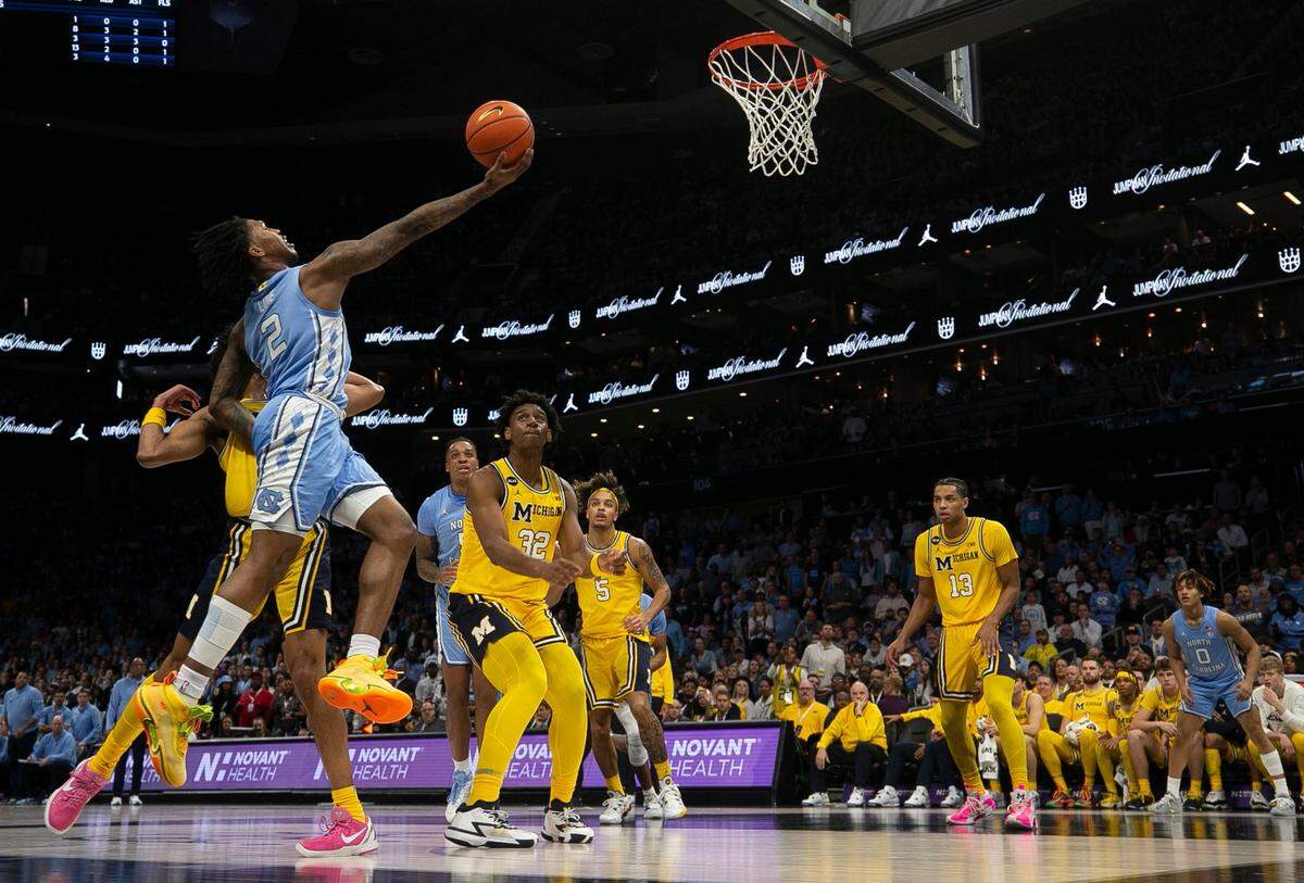 North Carolina’s Caleb Love (2) drives to the basket against Michigan’s Kobe Bufkin (2) in the second half on Wednesday, December 21, 2022 at the Spectrum Center in Charlotte, N.C.