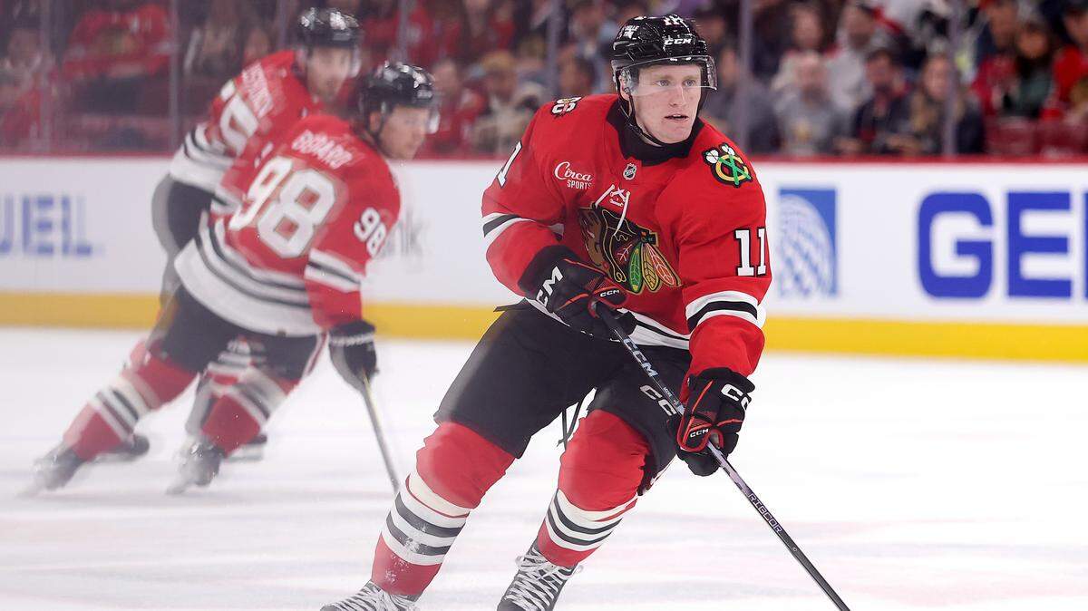 Oliver Moore (11) of the Chicago Blackhawks controls the puck against the New Jersey Devils during the third period at the United Center on Nov. 12, 2025 in Chicago, Illinois. Thursday in Raleigh, Moore had an assist, a fight and scored the winning shootout goal in a 4-3 Chicago win over Carolina.