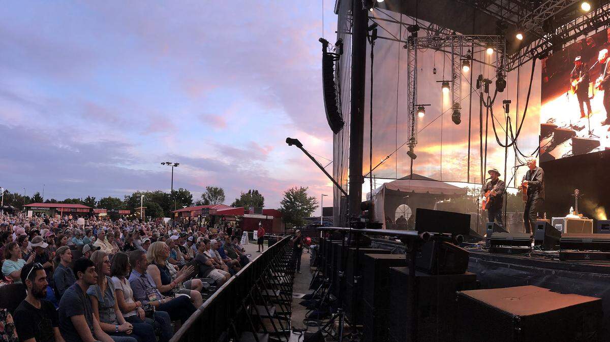 Trey Hensley, left, and Rob Ickes, right, perform with Tommy Emmanuel at the Red Hat Amphitheater during Raleigh’s World of Bluegrass in 2018. This year, the Red Hat Amphitheater shows will be free with select tickets available for purchase.