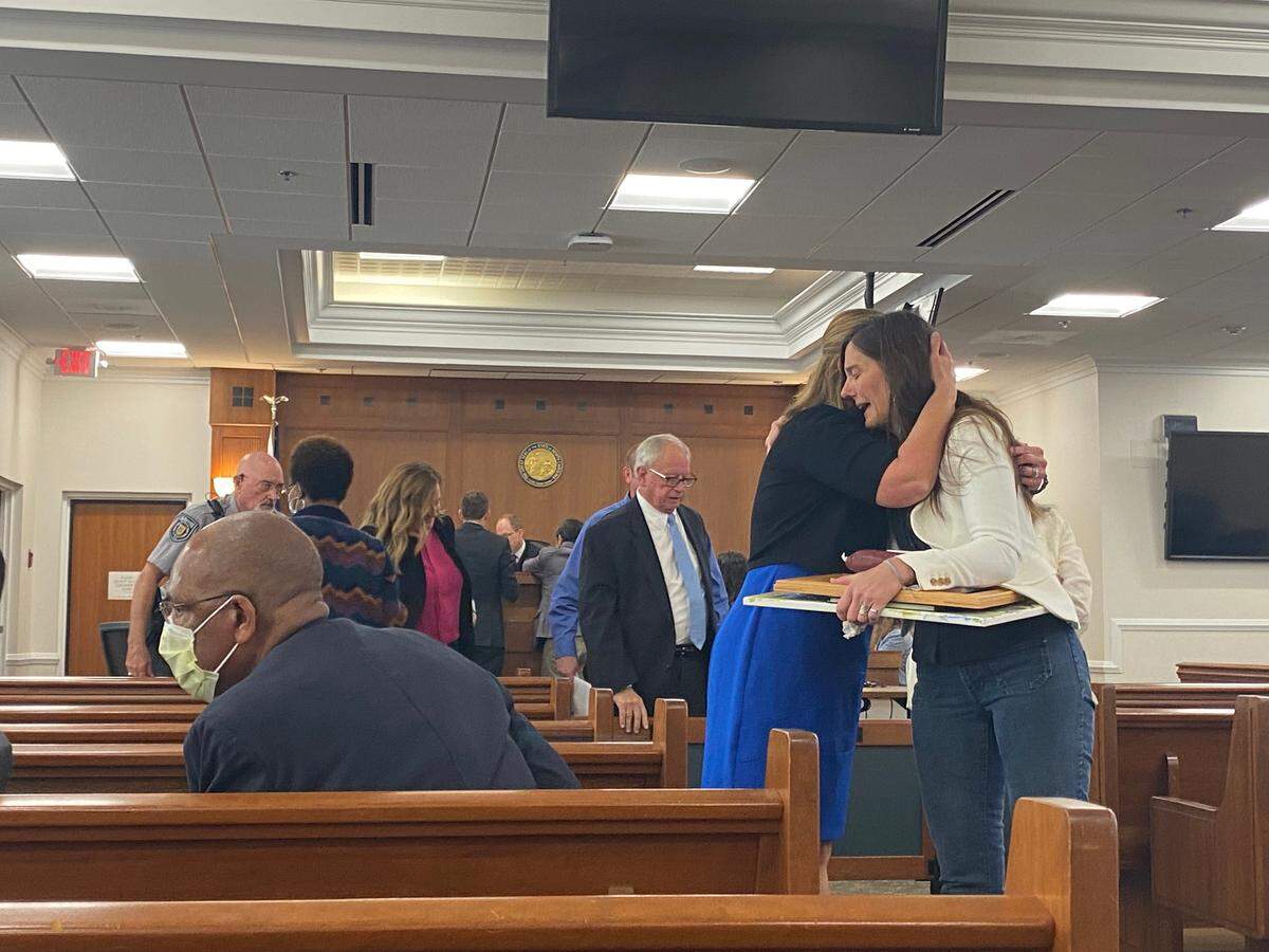Christie Barker-Cummings embraces Laura Windham after Windham’s husband pleaded guilty to involuntary manslaughter in the death of Barker-Cummings’ 18-year-old son.