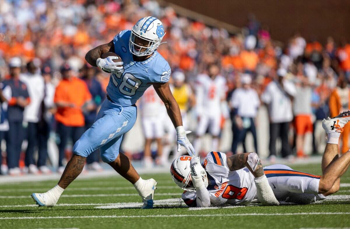 North Carolina running back Omarion Hampton (28) carries the ball for seven yards in the first quarter against Syracuse on Saturday, October 7, 2023 at Kenan Stadium in Chapel Hill, N.C.