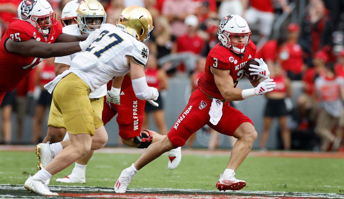 N.C. State running back Jordan Houston (3) escapes from Notre Dame linebacker JD Bertrand (27) during the first half of N.C. State’s game against Notre Dame at Carter-Finley Stadium in Raleigh, N.C., Saturday, Sept. 9, 2023.