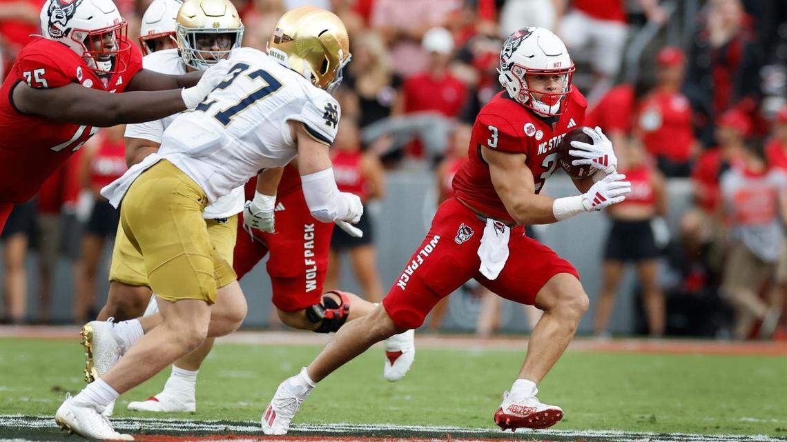 N.C. State running back Jordan Houston (3) escapes from Notre Dame linebacker JD Bertrand (27) during the first half of N.C. State’s game against Notre Dame at Carter-Finley Stadium in Raleigh, N.C., Saturday, Sept. 9, 2023.