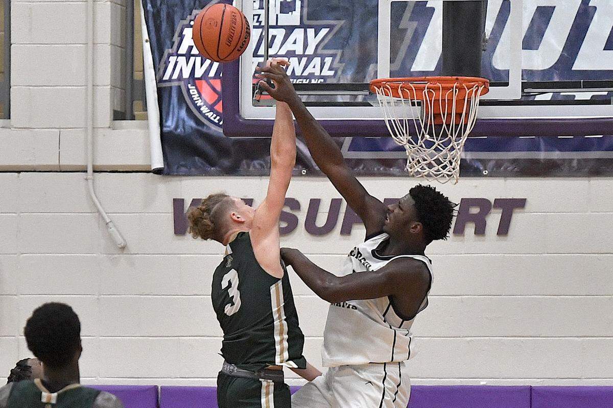 Reidsville’s Kendre Harrison (0) blocks the shot from Northwood’s Isaiah Blair (3) during the second half of their game in the John Wall Holiday Invitational. The Northwood Chargers and the Reidsville Rams met in a final of the John Wall Holiday Invitational in Raleigh, N.C. on December 30, 2023.