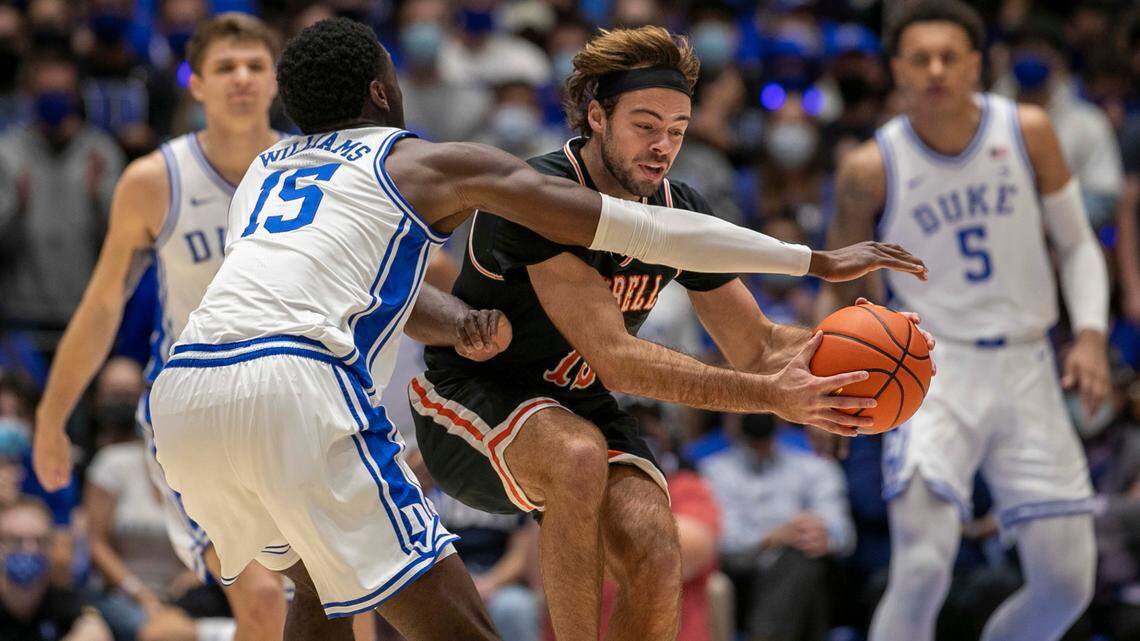 Duke’s Mark Williams (15) defends Campbell’s Austin McCullough (13) during the first half on Saturday, November 13, 2021 at Cameron Indoor Stadium in Durham, N.C.