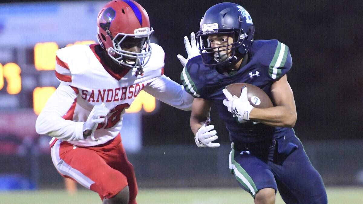 Noah Burnette, right, of Leesville Road moves the ball against Malachi Ruffin of Sanderson. The Sanderson Spartans visited the Leesville Road Pride in a high school football game on October 4, 2019.