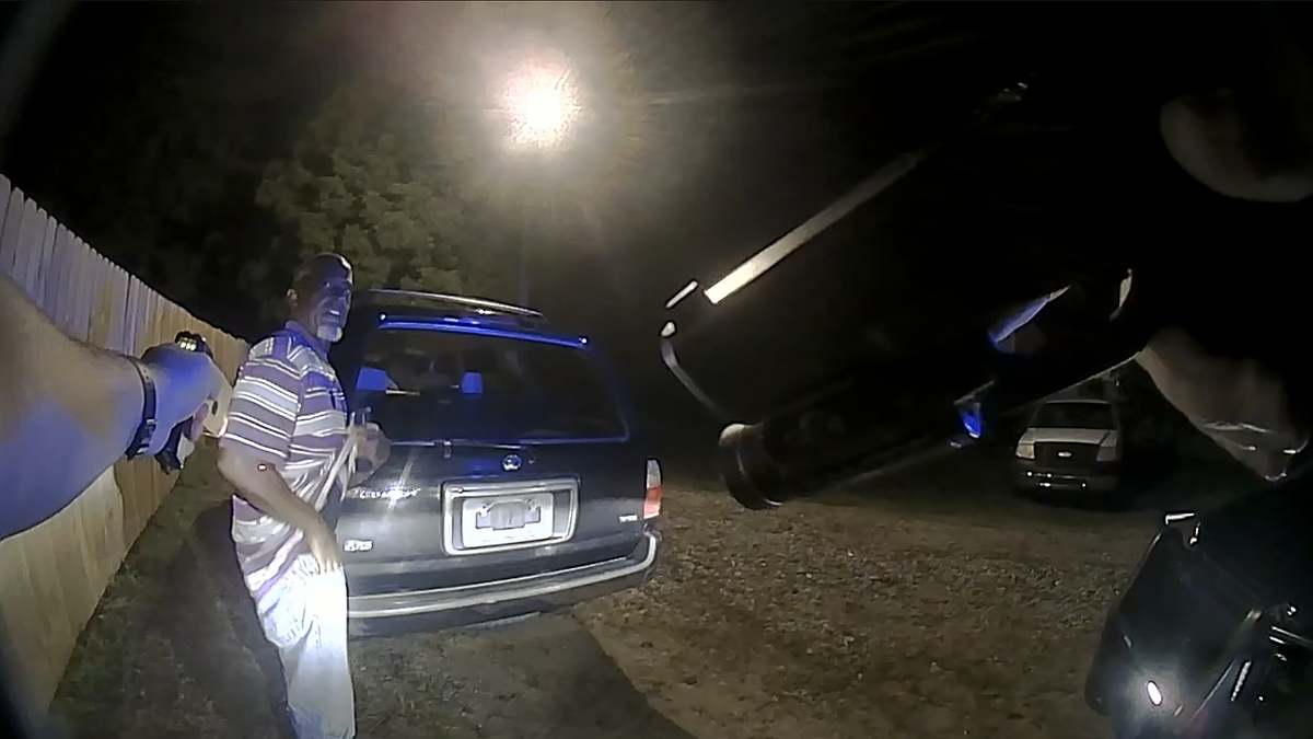 In an image taken from Warrenton Police Department body camera footage released by court order, former Officer Mark Oakley approaches Dwayne Hicks during a second stop on Sept. 20, 2023, this time with both his sidearm and his Taser drawn.