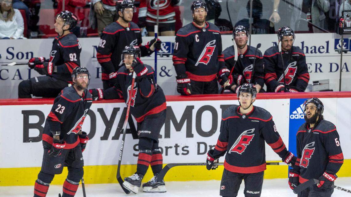 The Carolina Hurricanes, including center Martin Necas (88) and defenseman Jalen Chatfield (5) watch the video replay of the game winning goal in overtime by New York Rangers left wing Artemi Panarin (10), securing their 3-2 victory in Game 3 of the second round of the 2024 Stanley Cup playoffs on Thursday, May 9, 2024 at PNC Arena, in Raleigh N.C.