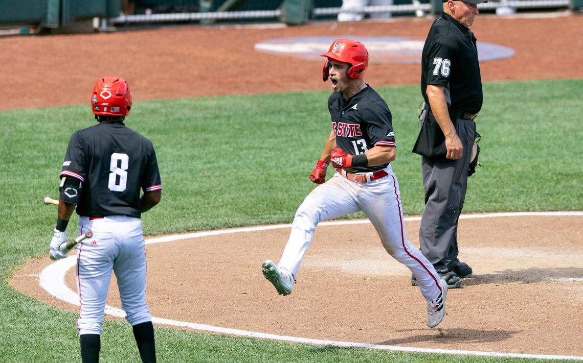 North Carolina State’s Tyler McDonough (13) celebrates after scoring off a single by Jonny Butler (14) in the ninth inning against Stanford in the opening baseball game of the College World Series Saturday, June 19, 2021, at TD Ameritrade Park in Omaha, Neb.