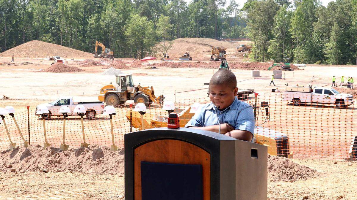 Aidan Jalloh, a rising fifth-grader from Hortons Creek Elementary School, introduces speakers at the groundbreaking ceremony on June 20, 2018 for the new Parkside Elementary School in Morrisville. It’s one of the new schools that Wake County is trying to fill in the 2019-20 student assignment plan.
