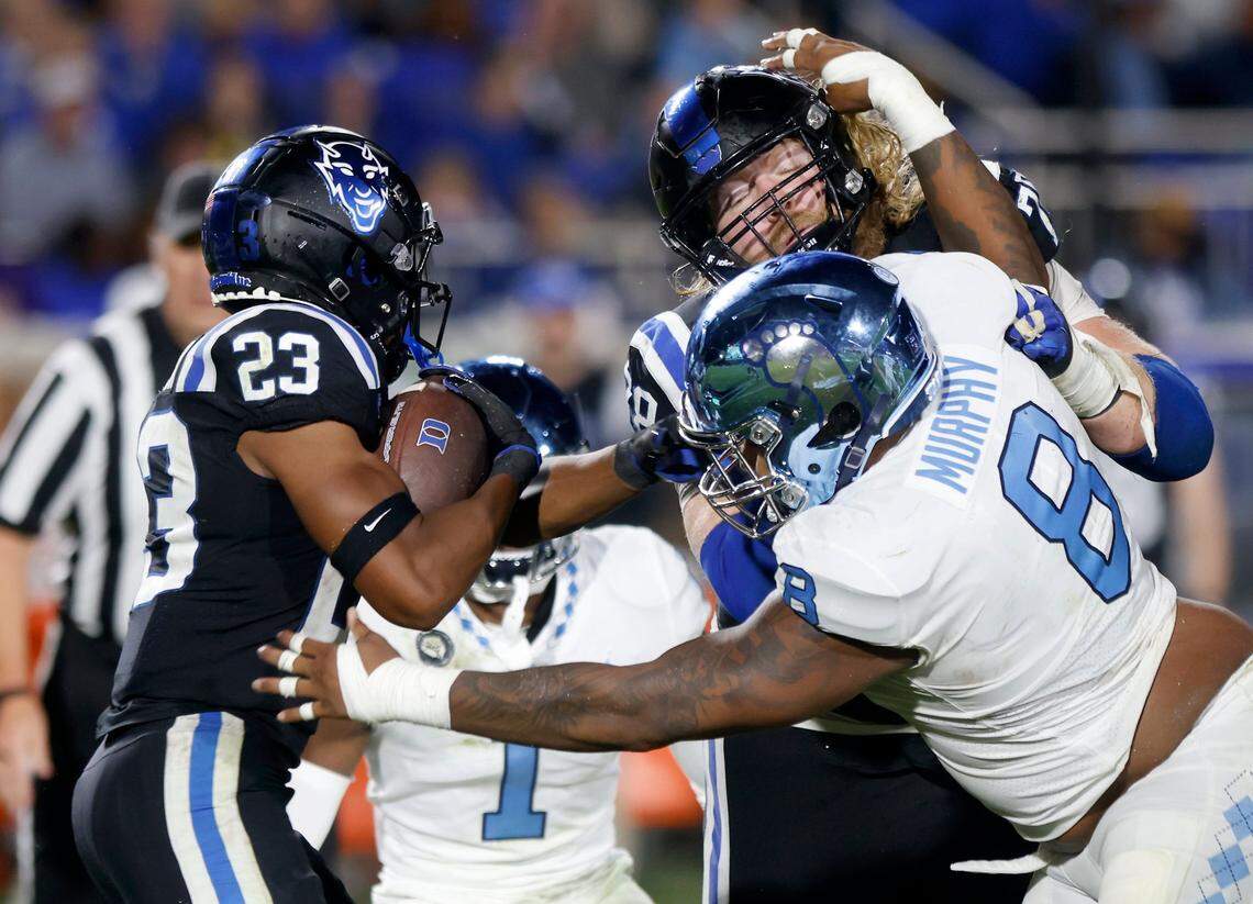 Duke Blue Devils running back Terry Moore carries the ball past North Carolina Tar Heels defensive lineman Myles Murphy during the second half of Saturday’s game at Wallace Wade Stadium in Durham, N.C.