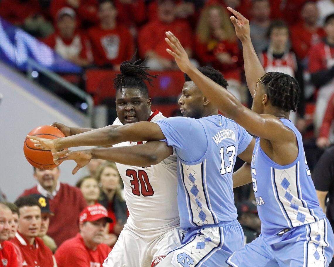 North Carolina’s Jalen Washington and Harrison Ingram pressure N.C. State’s DJ Burns Jr. during the first half of the Tar Heels’ 67-54 win at PNC Arena on Wednesday, Jan. 10, 2024, in Raleigh, N.C.