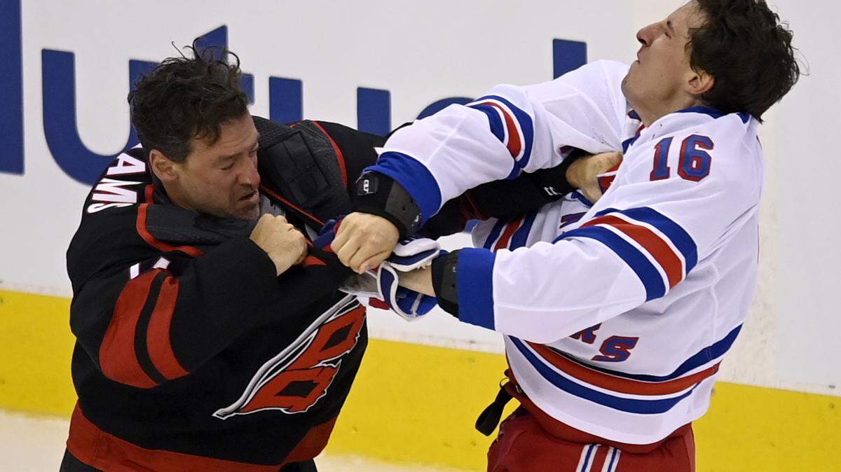 New York Rangers’ Ryan Strome (16) fights with Carolina Hurricanes’ Justin Williams during the first period in the NHL hockey Stanley Cup playoffs in Toronto, Saturday, Aug. 1, 2020. (Frank Gunn/The Canadian Press via AP)