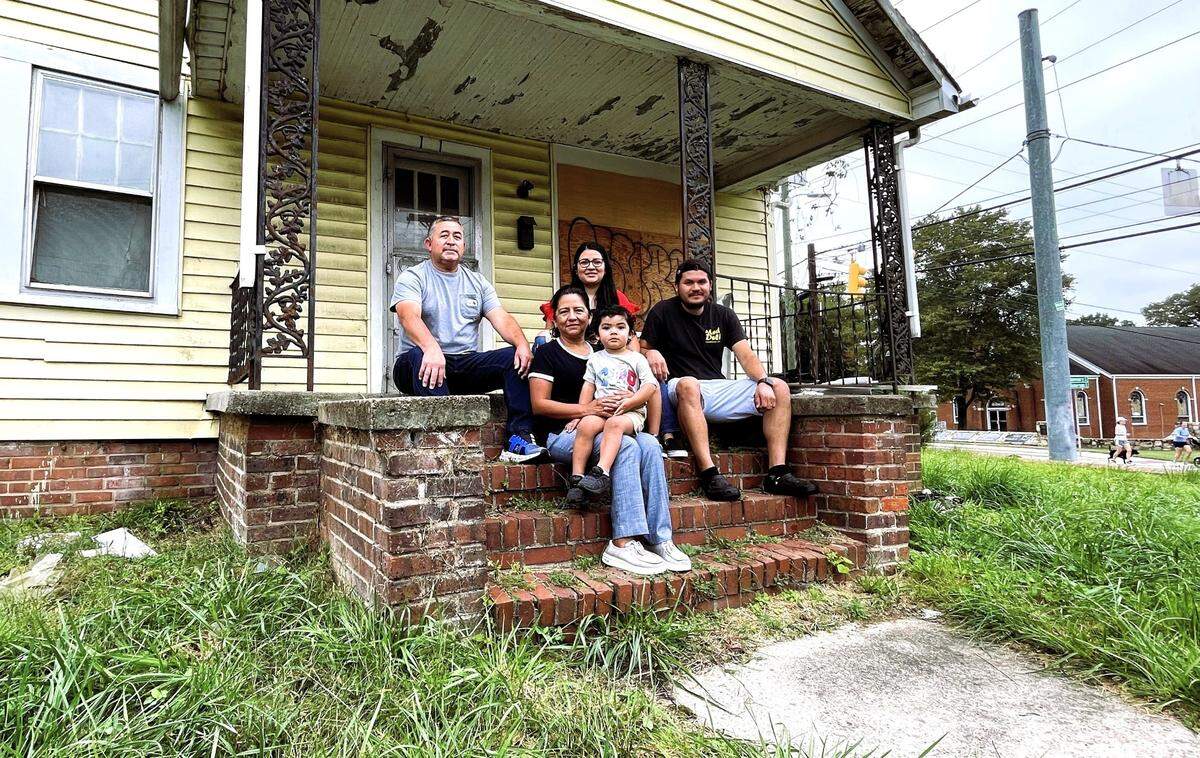 Edgar Ordonez (right), his wife Beatris Santillano, and her parents Ismael Santillano-Carrillo (left) and Norma Lazaro (holding her grandson), will open El Fogon next year after making extensive renovations to a long-vacant rental house at 111 N. Roberson St.