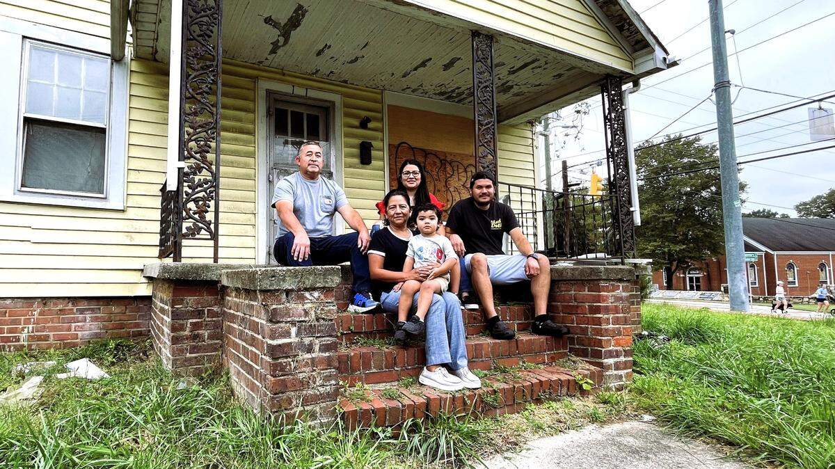 Edgar Ordonez (right), his wife Beatris Santillano, and her parents Ismael Santillano-Carrillo (left) and Norma Lazaro (holding her grandson), will open El Fogon next year after making extensive renovations to a long-vacant rental house at 111 N. Roberson St.