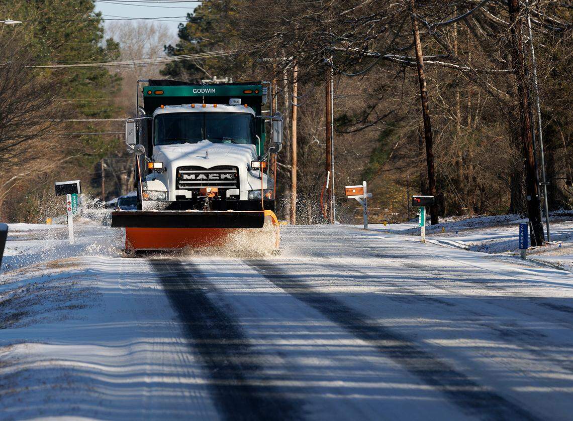 A snow plow works along Sparger Road on Wednesday, Jan. 22, 2025, in Durham, N.C.