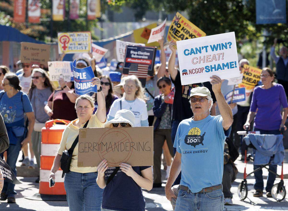 Demonstrators cross Jones Street en route to the Legislative Office Building during a rally on Tuesday, Oct. 21, 2025, organized by the North Carolina Democratic Party to protest the congressional redistricting proposal.